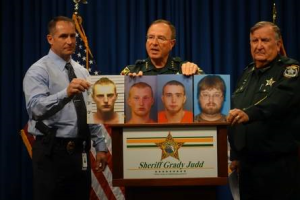 Grady Judd holding up a photo of the accused.